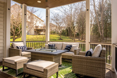 Mid-sized minimalist backyard ground level mixed material railing deck photo in DC Metro with a roof extension