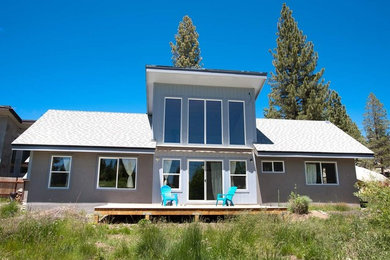 Example of a mid-sized minimalist gray two-story concrete house exterior design in Other with a shed roof