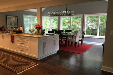Mid-sized transitional dark wood floor and brown floor kitchen/dining room combo photo in New York with gray walls and no fireplace
