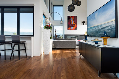 Inspiration for a large modern open concept dark wood floor and brown floor living room remodel in Vancouver with white walls, a standard fireplace, a metal fireplace and a wall-mounted tv
