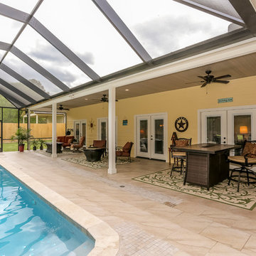 Patio with Fireplace with Screened Pool Enclosure