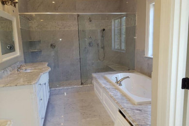 Drop-in bathtub - huge master marble tile marble floor, gray floor and single-sink drop-in bathtub idea in Boston with recessed-panel cabinets, white cabinets, gray walls, marble countertops, white countertops and a freestanding vanity