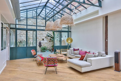 Design ideas for a large tropical open concept living room in Paris.