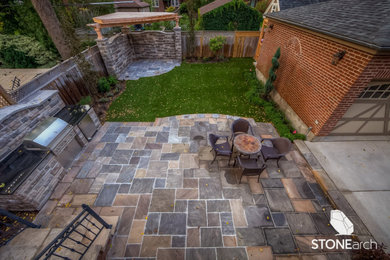 Patio - rustic backyard stone patio idea in Toronto with a fire pit and no cover