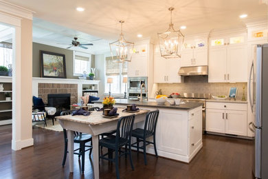 Eat-in kitchen - eclectic dark wood floor eat-in kitchen idea in Richmond with shaker cabinets, white cabinets, granite countertops, gray backsplash, ceramic backsplash, stainless steel appliances and an island
