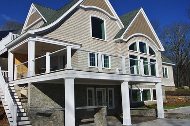 Large traditional two-storey exterior in Providence with wood siding.