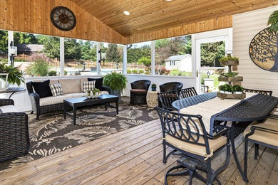Inspiration for a large mediterranean screened-in back porch remodel in DC Metro with decking and a roof extension