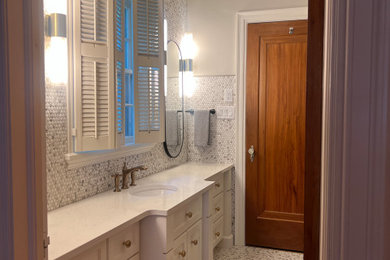 Inspiration for a mid-sized timeless master white tile and mosaic tile ceramic tile, white floor, single-sink and wainscoting bathroom remodel in Other with raised-panel cabinets, white cabinets, a two-piece toilet, gray walls, an undermount sink, quartz countertops, white countertops and a built-in vanity