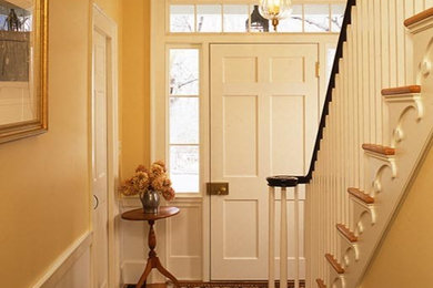 This is an example of a mid-sized traditional wood straight staircase in Boston with wood risers.