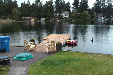 Example of a mid-sized classic backyard deck design in Seattle with no cover