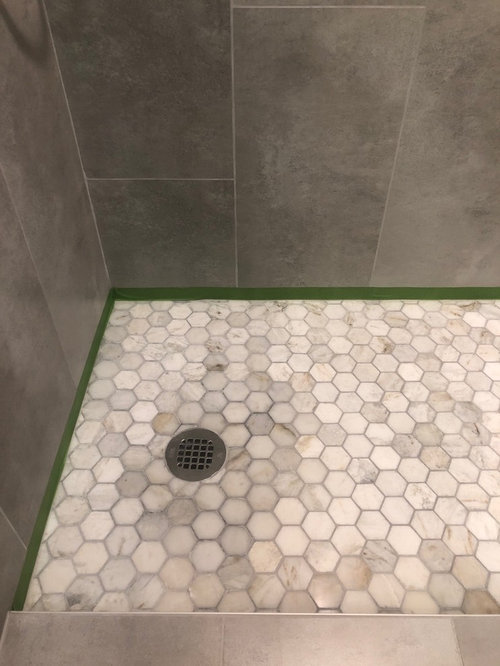 Discolored marble shower floor