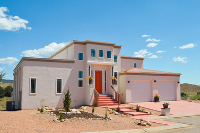 Inspiration for a large modern multicolored three-story stucco house exterior remodel in Other with a green roof and a red roof