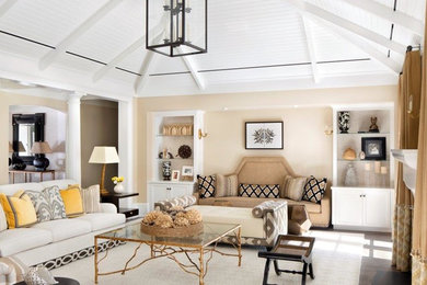 Inspiration for a large coastal open concept dark wood floor and brown floor family room remodel in Miami with beige walls and no fireplace