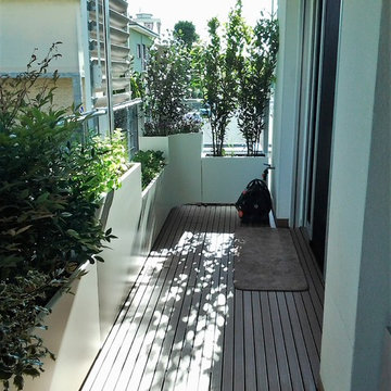 Terrazzo con fioriere bianche, panca e mascheramento