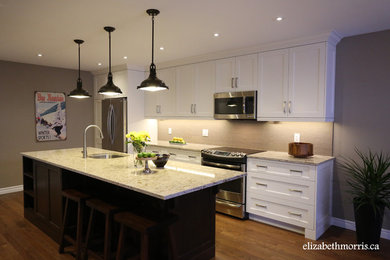 Mid-sized transitional galley dark wood floor eat-in kitchen photo in Toronto with a single-bowl sink, shaker cabinets, white cabinets, quartz countertops, gray backsplash, stone tile backsplash, stainless steel appliances and an island