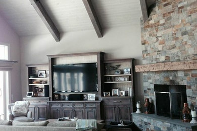 Example of a large mountain style open concept medium tone wood floor living room design in San Francisco with a music area, beige walls, a corner fireplace, a stone fireplace and a tv stand
