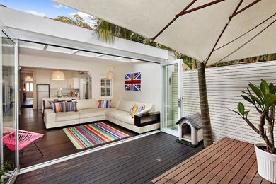 This is an example of a mid-sized modern courtyard deck in Sydney with no cover.