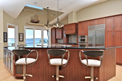 Example of a large transitional u-shaped light wood floor and brown floor open concept kitchen design in Tampa with an undermount sink, shaker cabinets, medium tone wood cabinets, quartz countertops, multicolored backsplash, mosaic tile backsplash, stainless steel appliances and two islands