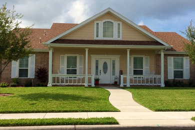 Inspiration for a large southwestern beige one-story brick exterior home remodel in Austin