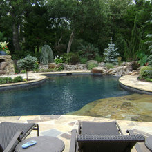 Pool with tanning deck, waterfall into pool, stone fireplace