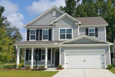 Example of a mid-sized classic gray two-story wood exterior home design in Charleston with a shingle roof