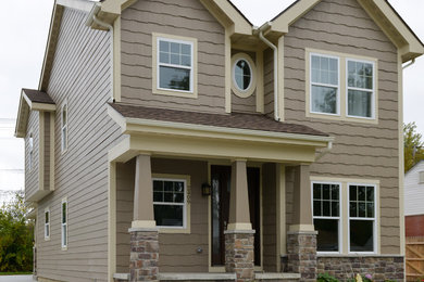 Example of a large trendy two-story vinyl exterior home design in Detroit