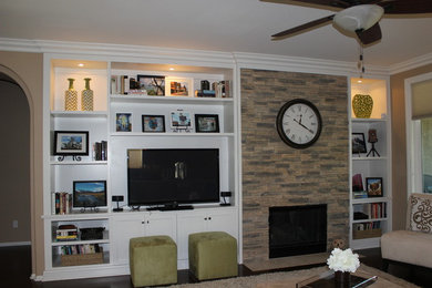 Minimalist dark wood floor living room photo in San Diego with beige walls, a standard fireplace, a stone fireplace and a tv stand