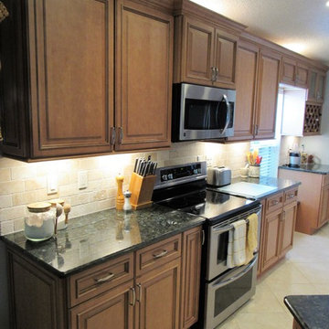 Galaxy Pecan cabinets with peacock green granite