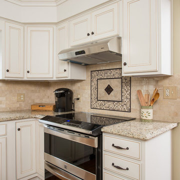 polished travertine backsplash with accent deco tile