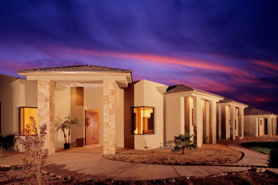 Mid-sized mediterranean beige one-story adobe exterior home idea in Albuquerque with a hip roof