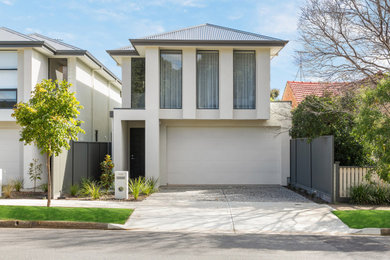 This is an example of a modern two-storey townhouse exterior in Adelaide with a metal roof and a grey roof.