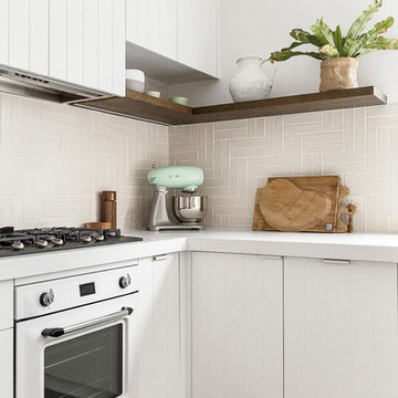 Coastal Kitchen with V-groove Cabinets and White Benchtops