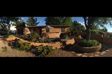 Example of a mid-sized southwest front yard gravel patio design in Albuquerque with no cover