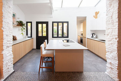 Aménagement d'une grande cuisine ouverte parallèle, encastrable, bicolore et blanche et bois éclectique en bois clair avec un évier intégré, un placard à porte affleurante, un plan de travail en quartz modifié, une crédence blanche, une crédence en céramique, un sol en carrelage de céramique, îlot, un sol gris, un plan de travail gris et plafond verrière.