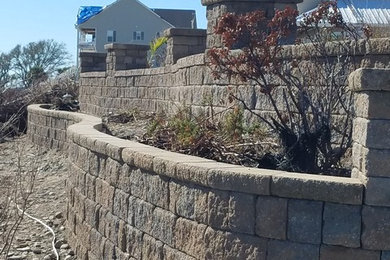 Inspiration for a large coastal full sun courtyard concrete paver landscaping in Other.