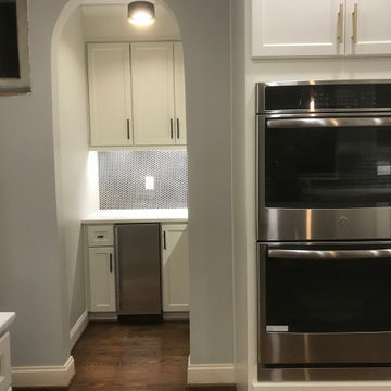 wall oven and coffee room with arch entrence