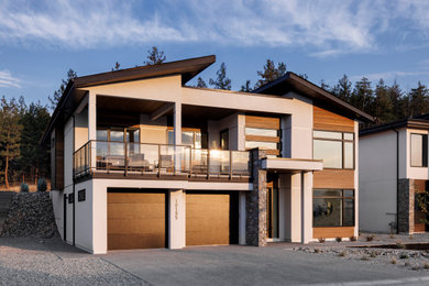 Example of a large trendy white two-story mixed siding exterior home design in Other with a mixed material roof and a black roof