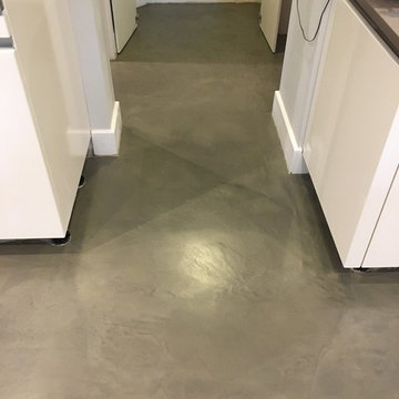 Polished concrete floor in bronze colour over existing floor tiles London
