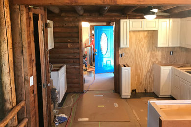 Eat-in kitchen - mid-sized transitional u-shaped exposed beam eat-in kitchen idea in Wichita with an undermount sink, raised-panel cabinets, granite countertops, multicolored backsplash, glass tile backsplash, stainless steel appliances, a peninsula and multicolored countertops