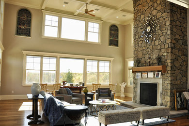 Huge elegant formal and loft-style medium tone wood floor living room photo in Boston with a standard fireplace, no tv, beige walls and a stone fireplace