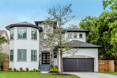 This is an example of a large contemporary two-storey grey exterior in Houston with mixed siding and a hip roof.