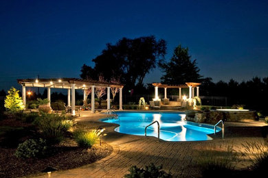 Example of a huge transitional backyard brick and custom-shaped lap hot tub design in New York