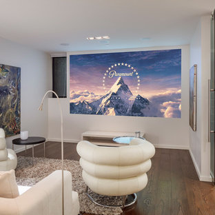 Inspiration for a mid-sized contemporary enclosed medium tone wood floor and beige floor home theater remodel in San Francisco with white walls and a projector screen