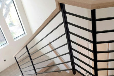Design ideas for a mid-sized contemporary wood u-shaped staircase in Dallas with painted wood risers.