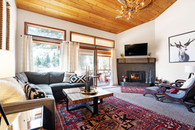 Family room - mid-sized transitional open concept carpeted, brown floor and wood ceiling family room idea in Other with white walls, a corner fireplace, a stone fireplace and a wall-mounted tv
