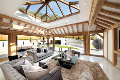 This is an example of a transitional enclosed family room in Buckinghamshire with white walls and a wall-mounted tv.