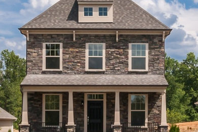 Mid-sized traditional three-story stone exterior home idea in Raleigh with a hip roof