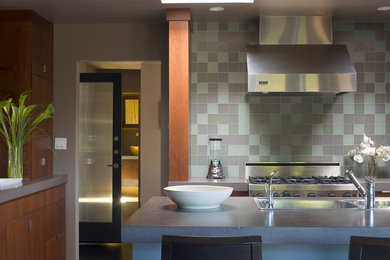 Inspiration for a transitional kitchen remodel in San Francisco with a double-bowl sink, medium tone wood cabinets, multicolored backsplash, stainless steel appliances and an island