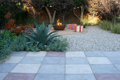 Contemporary backyard patio in Los Angeles with a fire feature and concrete pavers.