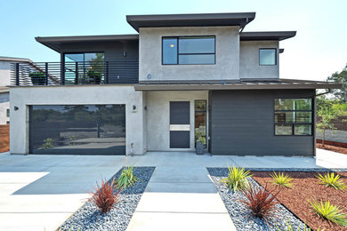 Example of a mid-sized minimalist beige two-story mixed siding house exterior design in San Francisco with a hip roof